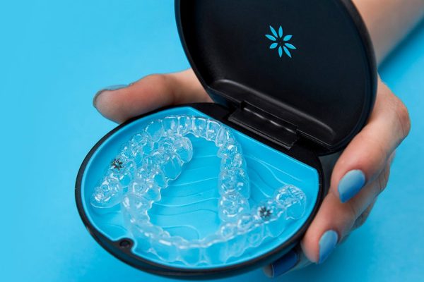 Cleaning Invisalign Aligners A close-up of Invisalign aligners being cleaned, ensuring proper hygiene during orthodontic treatment.