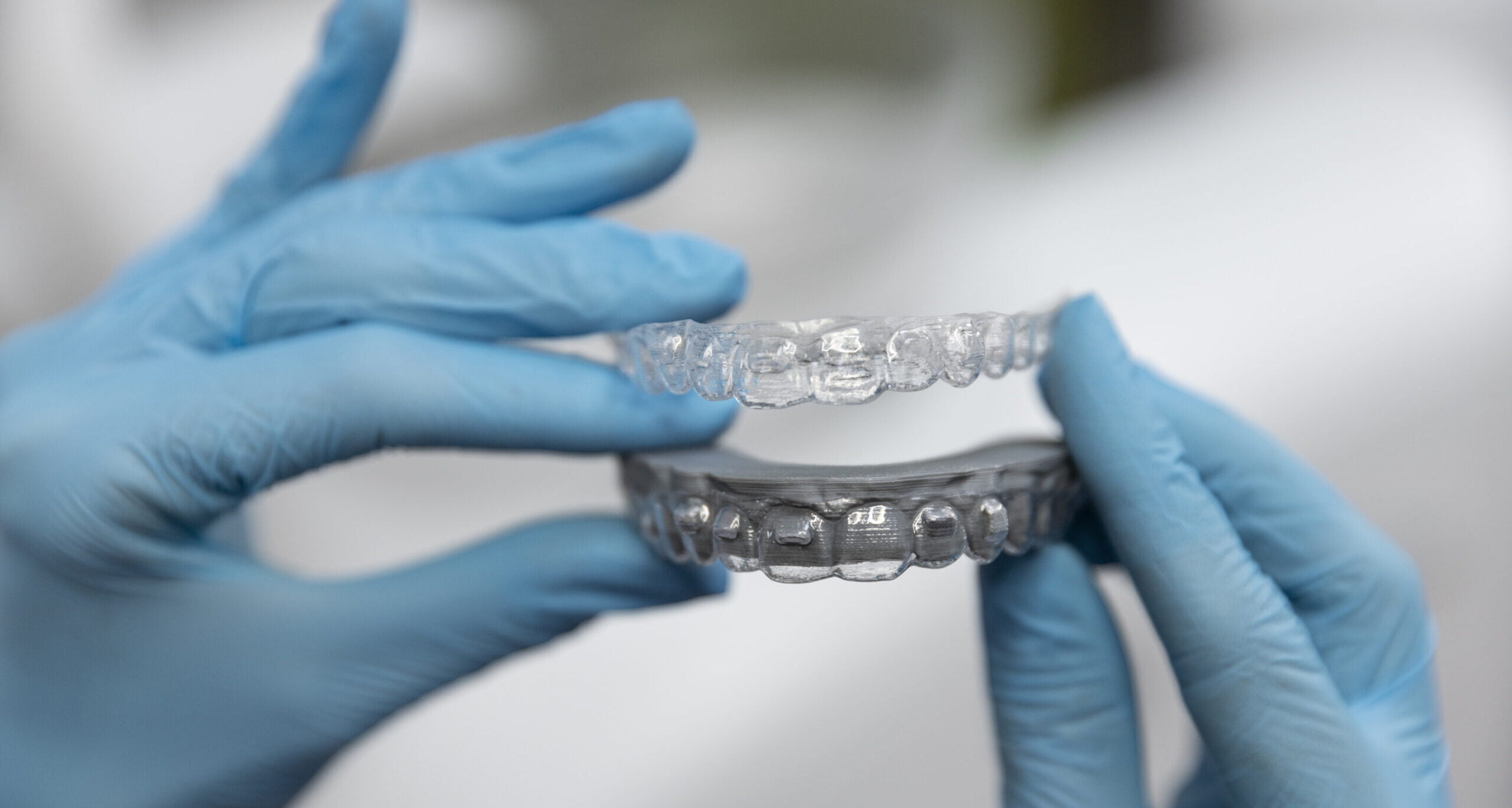 A close-up image of Invisalign clear aligners, designed to straighten teeth discreetly and comfortably.